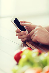 Image showing closeup of male hand pointing finger to smartphone