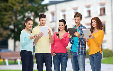 Image showing group of teenagers with smartphones and tablet pc