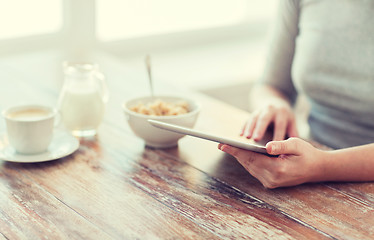 Image showing close up of woman reading news from tablet pc