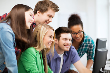 Image showing students looking at computer monitor at school