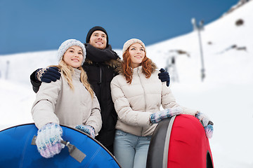 Image showing group of smiling friends with snow tubes