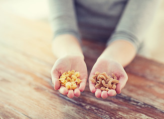 Image showing female hands with different pasta variations