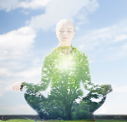 Image showing happy young woman doing yoga outdoors