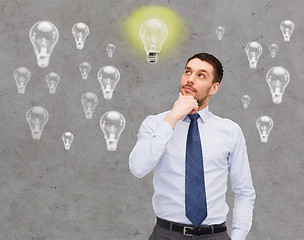 Image showing handsome businessman looking up and thinking