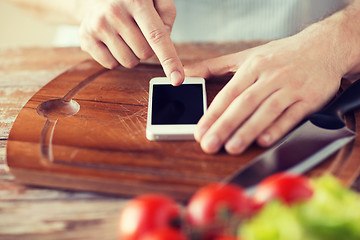 Image showing closeup of man pointing finger to smartphone