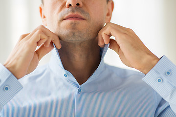 Image showing close up of man in shirt dressing 