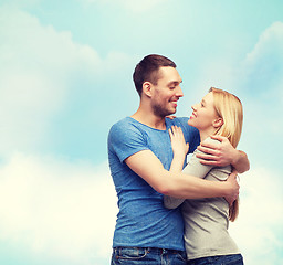 Image showing smiling couple hugging and looking at each other