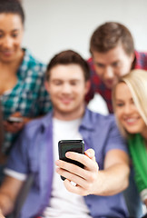 Image showing students looking at smartphone at school