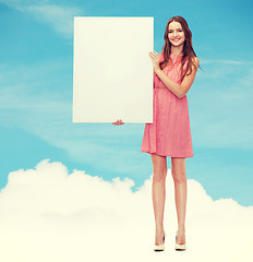 Image showing young woman in dress with white blank board