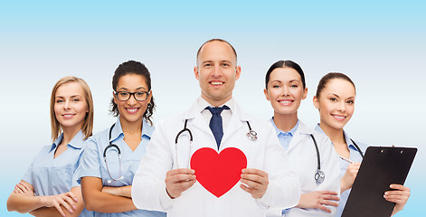 Image showing group of smiling doctors with red heart shape