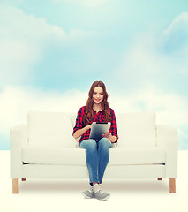 Image showing teenage girl sitting on sofa with tablet pc