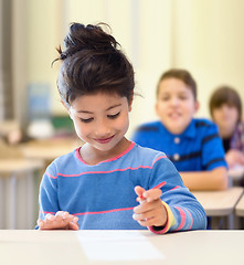 Image showing happy little school girl over classroom background