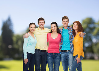 Image showing group of smiling teenagers over green park