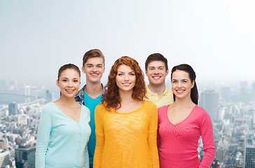 Image showing group of smiling teenagers over city background