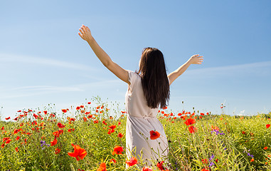 Image showing young woman on poppy field