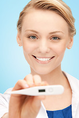 Image showing happy female doctor face with thermometer