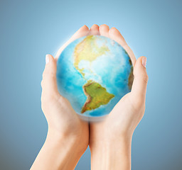 Image showing close up of human hands with earth globe