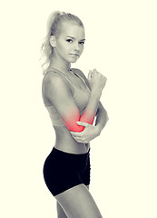 Image showing sporty woman with pain in elbow