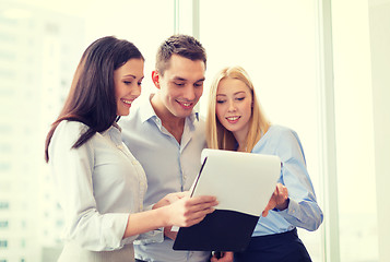 Image showing business team looking at clipboard