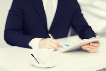 Image showing man with tablet pc and cup of coffee