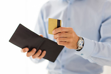 Image showing close up of man holding wallet and credit card