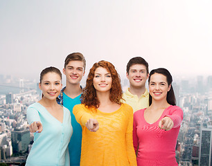 Image showing group of smiling teenagers over city background