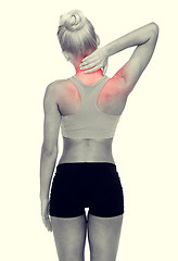 Image showing sporty woman touching her neck