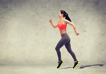 Image showing sporty woman running or jumping