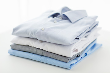 Image showing close up of ironed and folded shirts on table