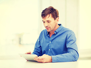 Image showing man working with tablet pc at home