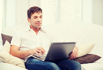 Image showing man working with laptop at home