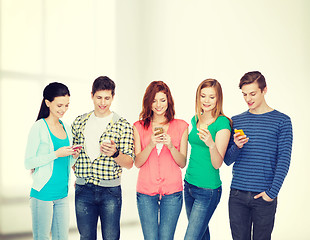 Image showing smiling students with smartphones