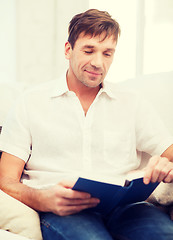 Image showing happy man with book at home