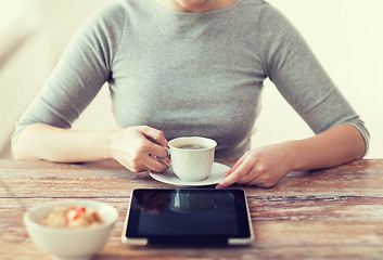 Image showing woman drinking coffee and using tablet pc