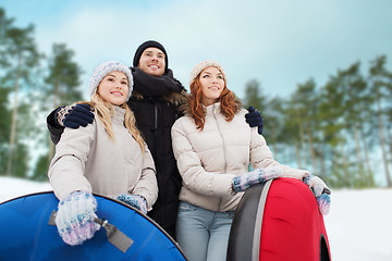 Image showing group of smiling friends with snow tubes