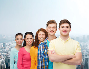 Image showing group of smiling teenagers over city background