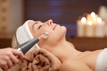 Image showing close up of young woman having face massage in spa