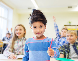 Image showing happy little school girl over classroom background