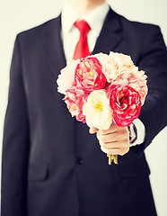Image showing man giving bouquet of flowers