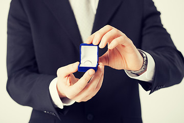 Image showing man with gift box and wedding ring