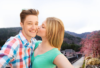 Image showing couple kissing and taking selfie over asian town