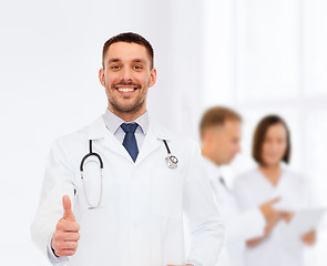 Image showing smiling doctor with stethoscope showing thumbs up