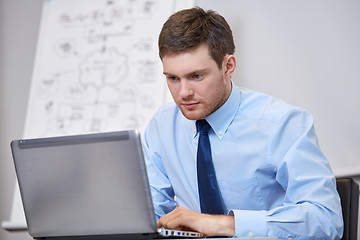 Image showing businessman sitting with laptop in office