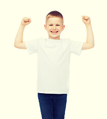 Image showing little boy in blank white t-shirt showing muscles