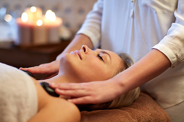 Image showing close up of woman having hot stone massage in spa