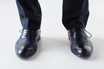 Image showing close up of man legs in elegant shoes with laces