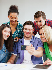 Image showing students looking into smartphone at school