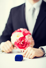 Image showing man with gift box in suit