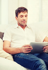 Image showing man working with tablet pc at home