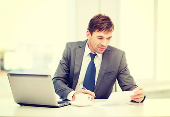 Image showing businessman with laptop computer and documents